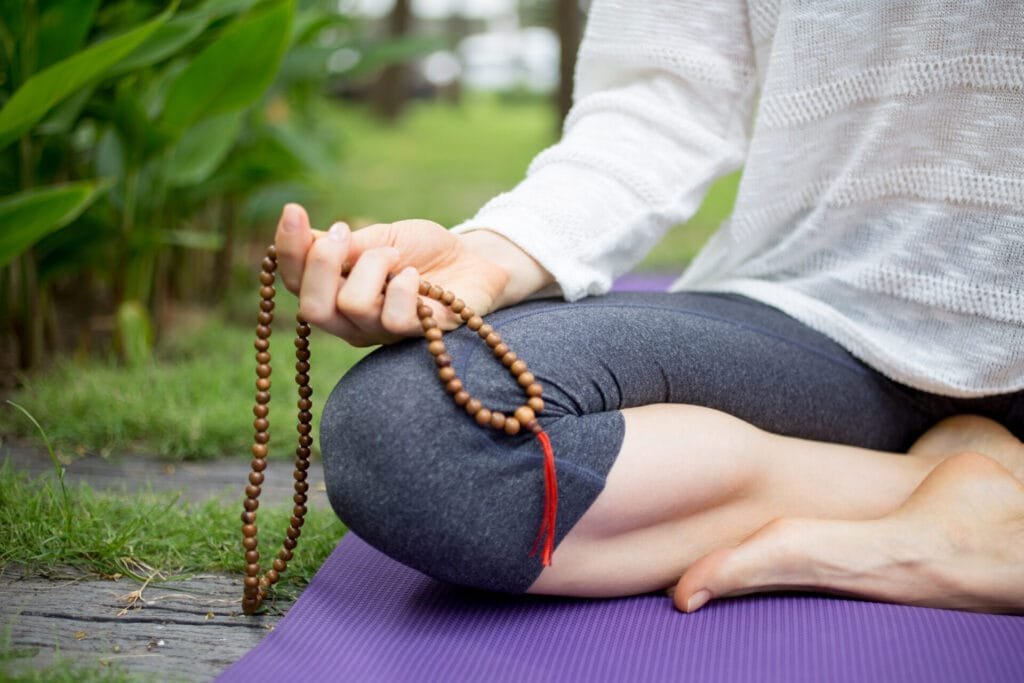 Approach Malas with Reverence hand woman sitting holding rosary beads
